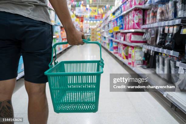 asian man shopping in kid section at supermarket. - image - retail stock illustrations stockfoto's en -beelden