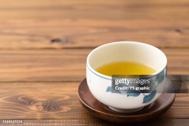 green tea poured into a japanese cup - ティーポット ストックフォトと画像