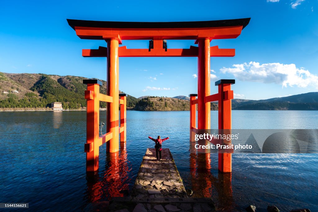 Hakone, JAPAN - April 15, 2019 : Traveler at red Torii gate of Hakone shrine located on lake Ashi, Japan. Gateways entrance to Shinto shrines and famous tourist landmark.