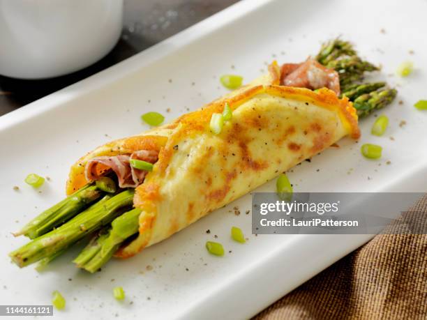 cheese omelet wrap with roasted asparagus and crispy prosciutto - omelette stock pictures, royalty-free photos & images