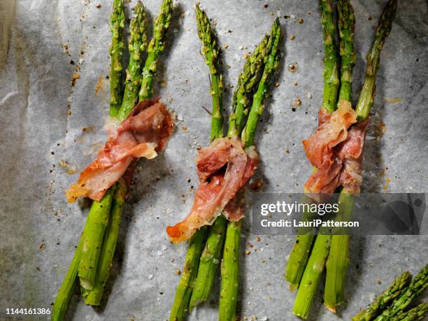 roasted asparagus wrapped in prosciutto - prosciutto wrapped stock pictures, royalty-free photos & images