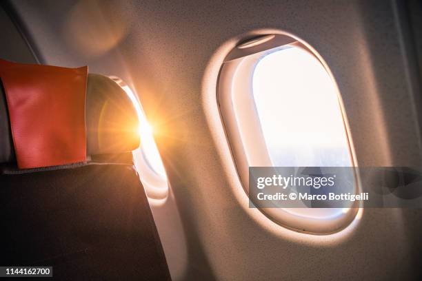 sunrise from passenger airplane seat - plane seat stockfoto's en -beelden