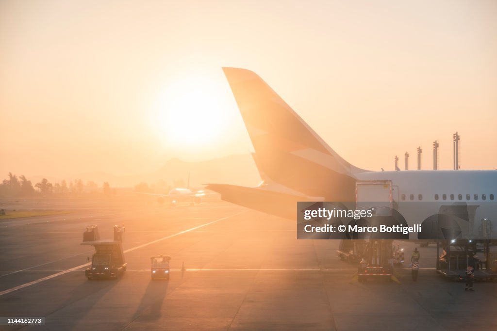 Airplanes at the airport at sunrise