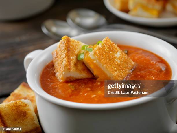 roasted tomato, garlic and basil soup with grilled cheese croutons - tomato soup stock pictures, royalty-free photos & images