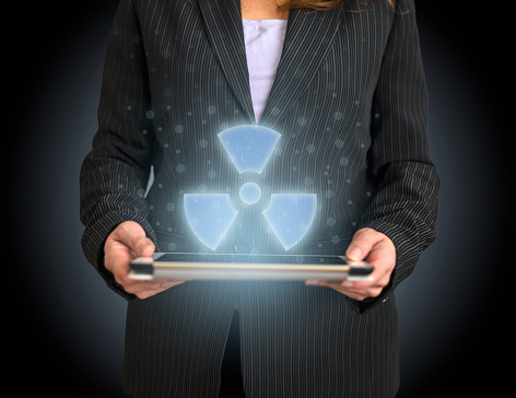 Nuclear Energy icon on tablet with hologram