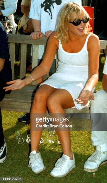Samantha Janus, a British actress, singer and model, gestures whilst watching a celebrity cricket match for charity at Holbrook cricket ground, near...