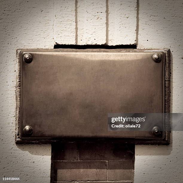 bronze plaque on a wall background with copy space - bronze stock pictures, royalty-free photos & images