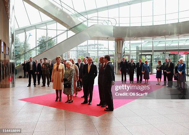 Queen Elizabeth II, Prince Philip, Duke of Edinburgh, Irish President Mary McAleese and her husband Martin McAleese listen to live classical music as...