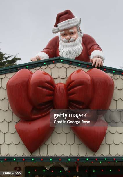 Santa Claus statue adorns the roof of The Christmas Cottage as viewed in this coastal community on April 7 in Lincoln City, Oregon. Oregon's diverse...