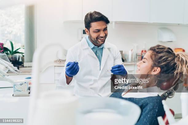 young woman during a dental check-up - dentista imagens e fotografias de stock