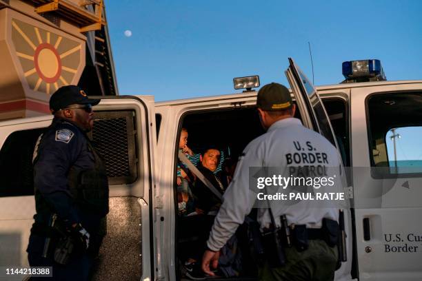 Migrants, mostly from Central America, board a van which will take them to a processing center, on May 16 in El Paso, Texas. - About 1,100 migrants...