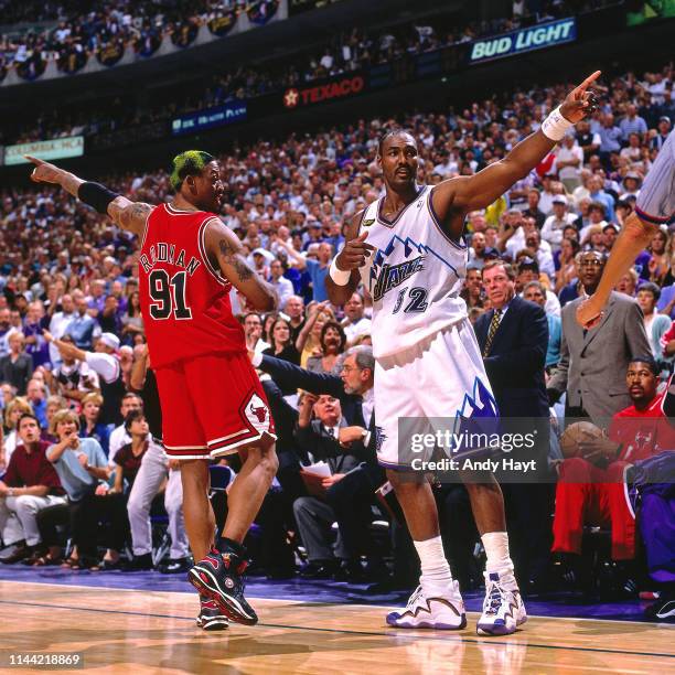 Dennis Rodman of the Chicago Bulls and Karl Malone of the Utah Jazz react to a play during Game Six of the 1998 NBA Finals on June 14, 1998 at the...