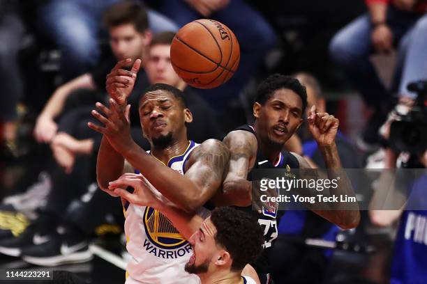 Lou Williams of the Los Angeles Clippers fights for a rebound against Alfonzo McKinnie and Klay Thompson of the Golden State Warriors during the...
