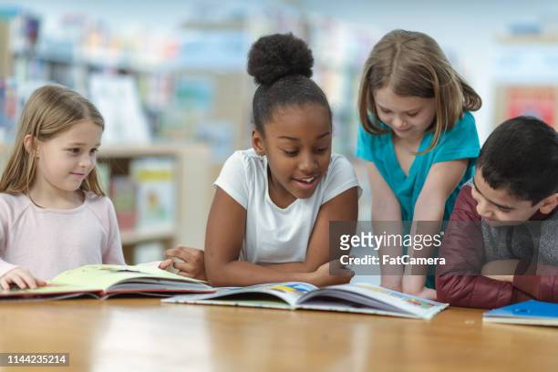 children reading - small group of people stock pictures, royalty-free photos & images