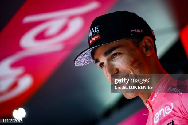 Team UAE Emirates rider Italy's Valerio Conti smiles as he celebrates his overall leader pink jersey on the podium of stage seven of the 102nd Giro...