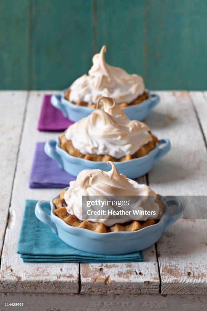 Chocolate tart w/meringue tops on rustic table