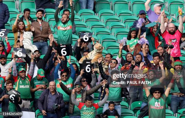Bangladesh supporters celebrate during the one-day international Tri-Nation Series final between Bangladesh and West Indies at the Malahide cricket...