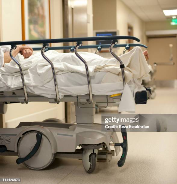 patient in hospital bed - hospital gurney stock pictures, royalty-free photos & images