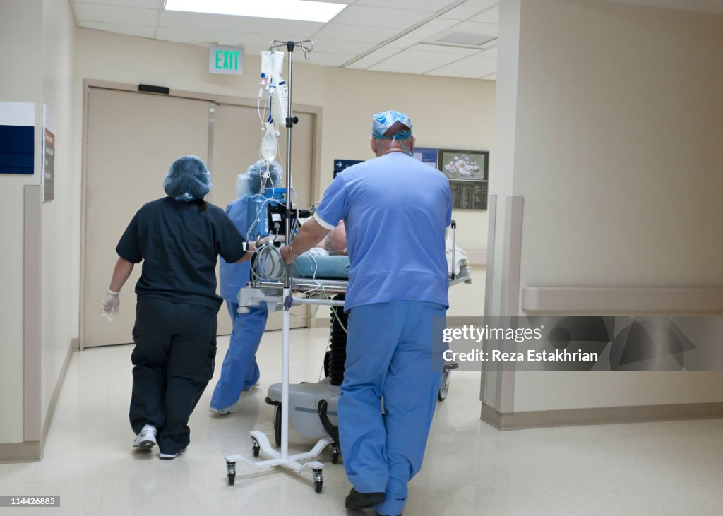 Patient being rushed through hospital corridor