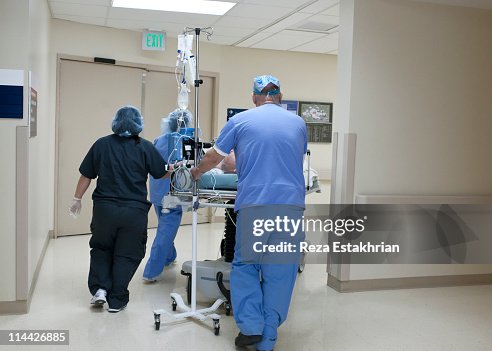 Patient Rushed Patient Being Rushed Through Hospital Corridor High-Res Stock Photo ...