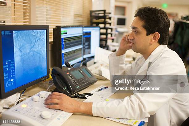 doctor checks angiogram - angiogram stock pictures, royalty-free photos & images