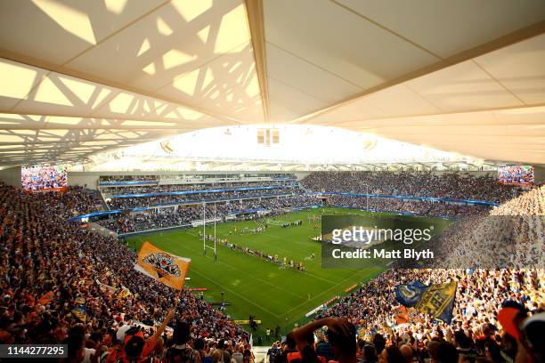 Eels and Tigers player sing the national anthem before the round 6 NRL match between the Parramatta Eels and Wests Tigers at Bankwest Stadium on...