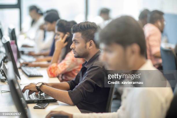 female and male entrepreneurs working at office - india stock pictures, royalty-free photos & images