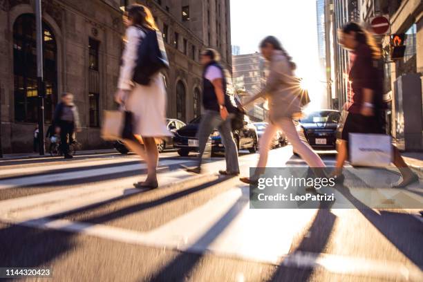 crosswalk, people crossing in downtown - pedestrians walking stock pictures, royalty-free photos & images