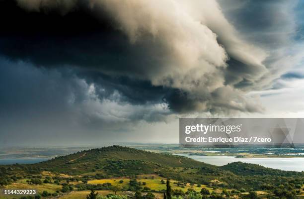 dark storm clouds over the river guadiana, portugal - eye of the storm stock pictures, royalty-free photos & images