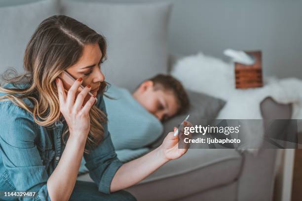 motherly tenderness - woman home with sick children imagens e fotografias de stock