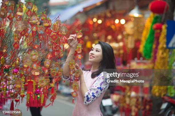 beautiful vietnamese girl in traditional dress - tet vietnam stock pictures, royalty-free photos & images