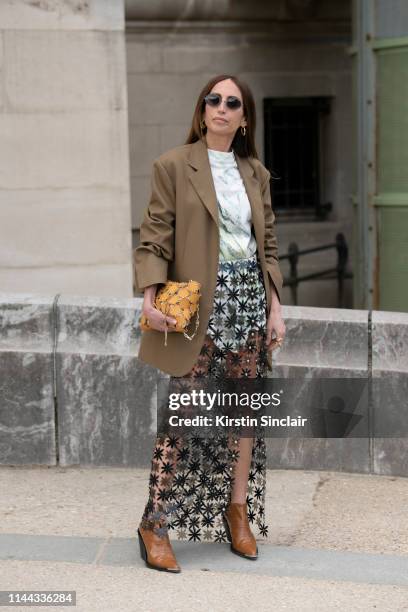 Fashion Consultant and digital Influencer Chloe Harrouche of Loulou de Saison wears a Paco Rabanne skirt, top, shoes and bag and a Celine jacket on...