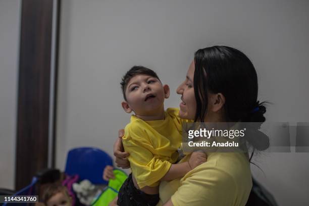 Mothers of the Association Miracles of God - Sons of Zika perform neurological exercises for children with microcephaly in Neiva, Huila, Colombia on...