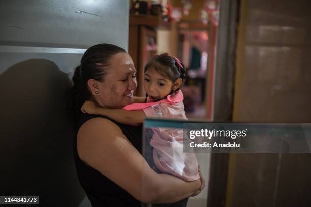 Samantha and her aunt, who is closed present in the life of the girl, play at home in Neiva, Huila, Colombia on May 13, 2019. A generation of...