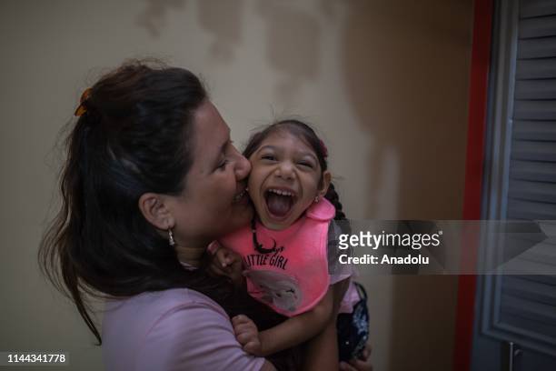 Samantha, 3 years old, and her mother, Jéssica, play at home in Neiva, Huila, Colombia on May 13, 2019. A generation of children with microcephaly...