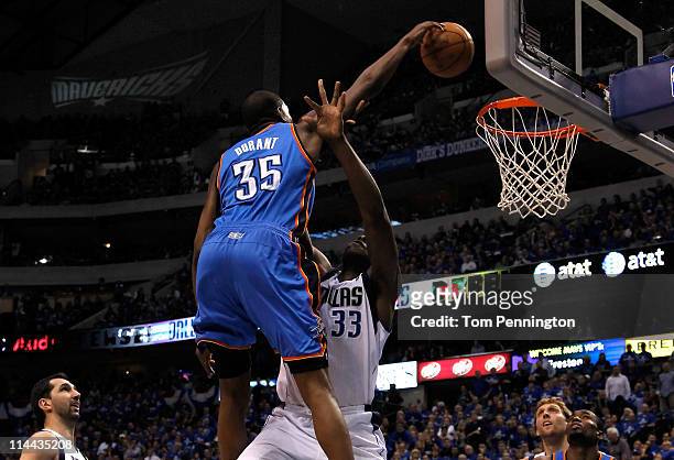 Kevin Durant of the Oklahoma City Thunder dunks the ball over Brendan Haywood of the Dallas Mavericks as Haywood is called for a foul in the first...