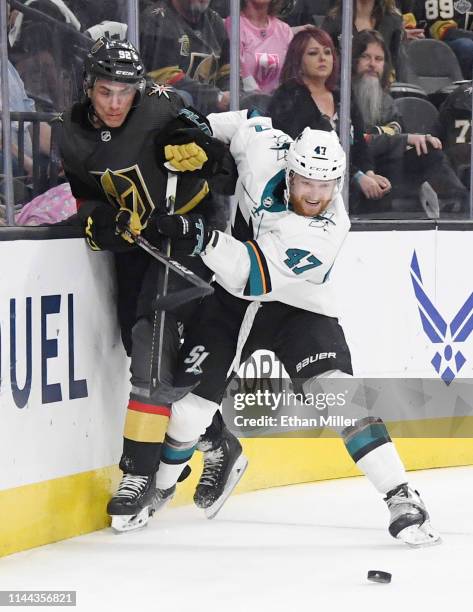 Joakim Ryan of the San Jose Sharks checks Tomas Nosek of the Vegas Golden Knights into the boards as they go after a loose puck in the second period...