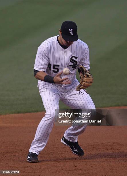 Dallas McPherson of the Chicago White Sox bobbles the ball against the Cleveland Indians at U.S. Cellular Field on May 19, 2011 in Chicago, Illinois.