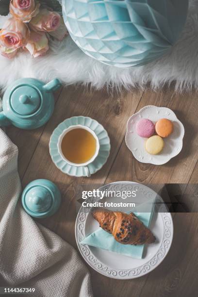 party table with macaroons, tea and croissant - cup of tea from above stock pictures, royalty-free photos & images