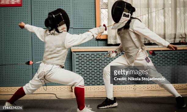 young fencers - conflict of interest stock pictures, royalty-free photos & images