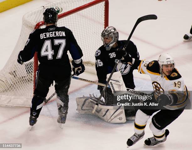 Marc-Andre Bergeron and Dwayne Roloson of the Tampa Bay Lightning react as Tyler Seguin of the Boston Bruins scores a third period goal in Game Three...