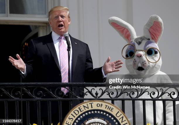 President Donald Trump, accompanied by a person dressed as the Easter Bunny, welcomes guests with opening remarks during the 141st Easter Egg Roll on...