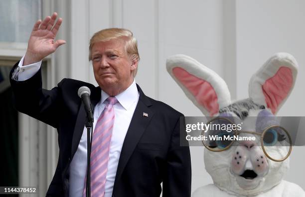 President Donald Trump, accompanied by a person dressed as the Easter Bunny, welcomes guests with opening remarks during the 141st Easter Egg Roll on...