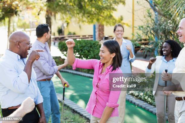 corporate team building, playing miniature golf - mini golf stock pictures, royalty-free photos & images