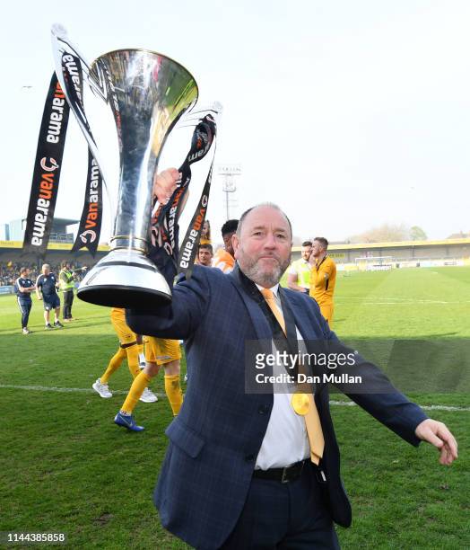 Gary Johnson, Manager of Torquay United celebrates with the Vanarama National League South Trophy as Torquay United are crowned champions following...