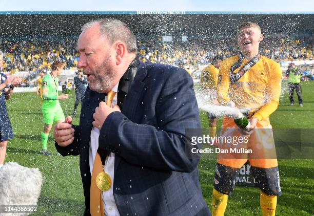 Gary Johnson, Manager of Torquay United is sprayed with champagne in celebration as Torquay United are crowned champions of the Vanarama National...