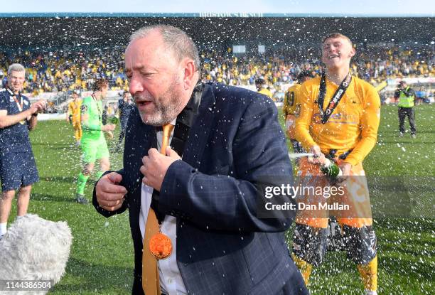 Gary Johnson, Manager of Torquay United is sprayed with champagne in celebration as Torquay United are crowned champions of the Vanarama National...