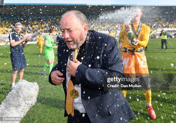 Gary Johnson, Manager of Torquay United is sprayed with champagne in celebration as Torquay United are crowned champions of the Vanarama National...