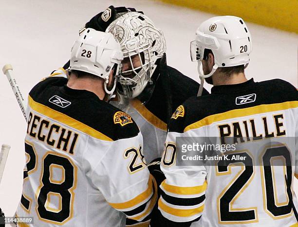 Tim Thomas celebrates with Mark Recchi and Daniel Paille of the Boston Bruins after they defeated the Tampa Bay Lightning 2 to 0 in Game Three of the...