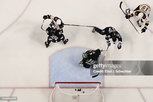 Marc-Andre Bergeron, Dwayne Roloson of the Tampa Bay Lightning and Chris Kelly of the Boston Bruins react as Tyler Seguin of the Boston Bruins scores...